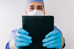 Doctor Holding out a Bible  image 2