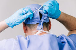 Doctor Tying on a Medical Mask  image 2