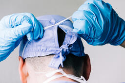Doctor Tying on a Medical Mask  image 1