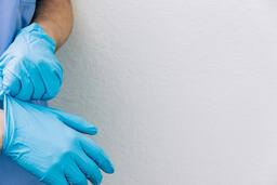 Doctor Putting Medical Gloves On  image 2
