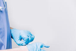 Doctor Putting Medical Gloves On  image 1