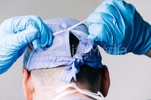Doctor Tying on a Medical Mask