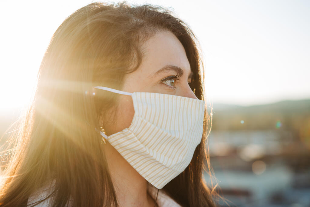 Woman Wearing a Face Mask at Sunrise large preview