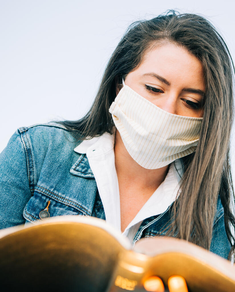 Woman Wearing a Face Mask and Reading the Bible large preview