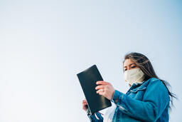 Woman Wearing a Face Mask and Reading the Bible  image 5