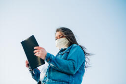 Woman Wearing a Face Mask and Reading the Bible  image 8