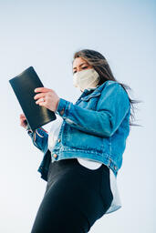 Woman Wearing a Face Mask and Reading the Bible  image 2