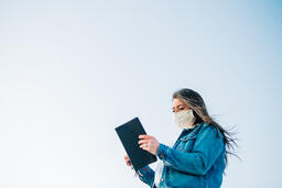 Woman Wearing a Face Mask and Reading the Bible  image 7