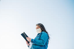 Woman Wearing a Face Mask and Reading the Bible  image 3