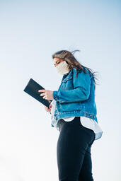 Woman Wearing a Face Mask and Reading the Bible  image 1