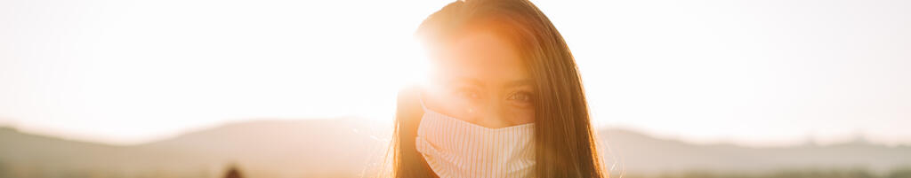 Woman Wearing a Face Mask at Sunrise large preview