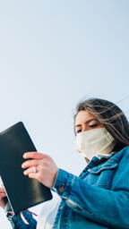 Woman Wearing a Face Mask and Reading the Bible  image 3