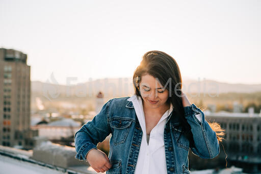 Woman Standing on a Rooftop at Sunrise