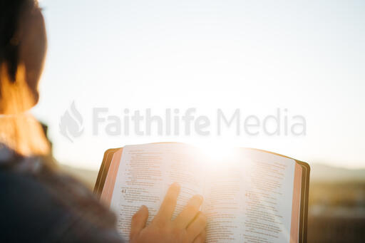 Woman Reading the Bible at Sunrise