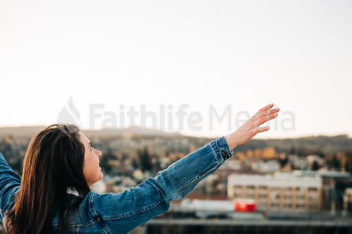 Woman with Hands Raised in Worship
