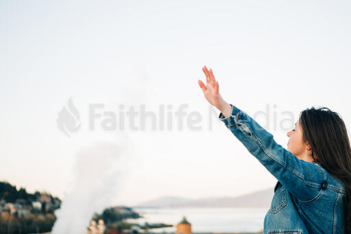 Woman with Hands Raised in Worship