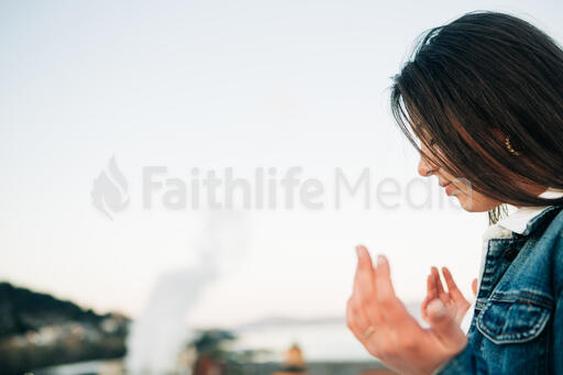 Woman with Hands Raised in Prayer