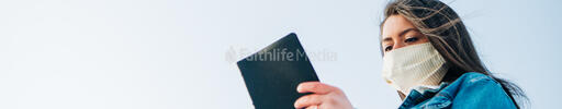 Woman Wearing a Face Mask and Reading the Bible