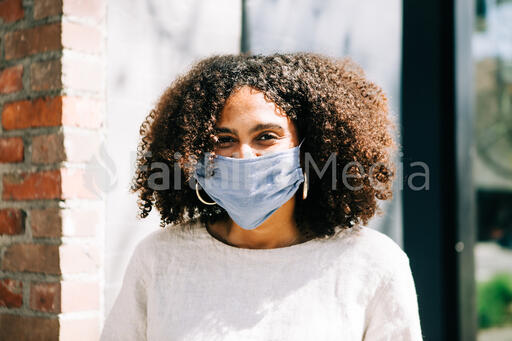 Woman Wearing a Mask and Smiling