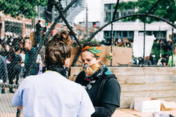 Volunteer Nurse Speaking with a Peaceful Protester  image 1