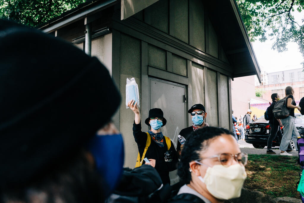 Peaceful Protesters Handing Out Face Masks large preview