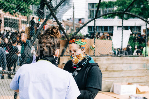 Volunteer Nurse Speaking with a Peaceful Protester