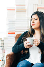Woman Drinking Coffee Surrounded by Books  image 2