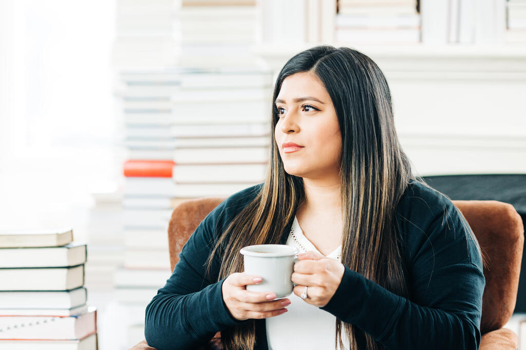 Woman Drinking Coffee Surrounded by Books large preview