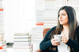 Woman Drinking Coffee Surrounded by Books  image 3