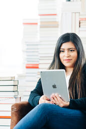 Woman Studying on an iPad in a Living Room full of Books  image 4