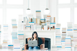 Woman Studying on a Laptop in a Living Room Full of Books  image 7