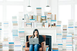 Woman Studying on a Laptop in a Living Room Full of Books  image 5