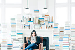 Woman Studying on an iPad in a Living Room Full of Books  image 4