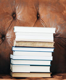 A Stack of Books on a Chair Surrounded by Books  image 4