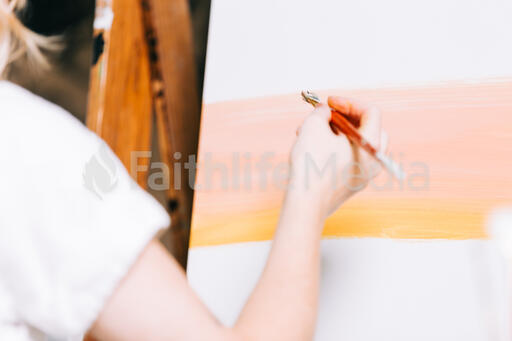 A Woman Painting a Canvas