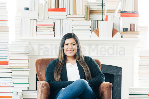 A Woman Sitting Surrounded by Books