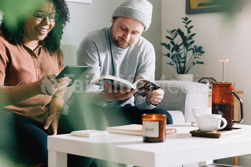 Couple Reading Together in the Living Room