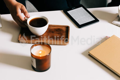 Woman Grabbing a Mug From the Coffee Table