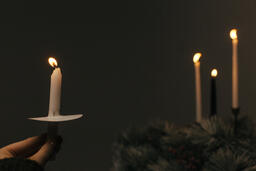 Hand Holding a Candle for a Christmas Candlelight Service  image 6