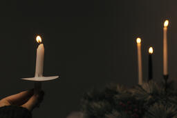 Hand Holding a Candle for a Christmas Candlelight Service  image 5