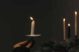 Hand Holding a Candle for a Christmas Candlelight Service  image 2