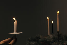 Hand Holding a Candle for a Christmas Candlelight Service  image 4