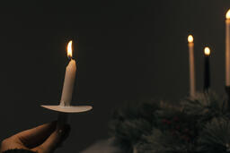Hand Holding a Candle for a Christmas Candlelight Service  image 3