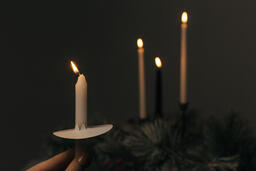 Hand Holding a Candle for a Christmas Candlelight Service  image 1