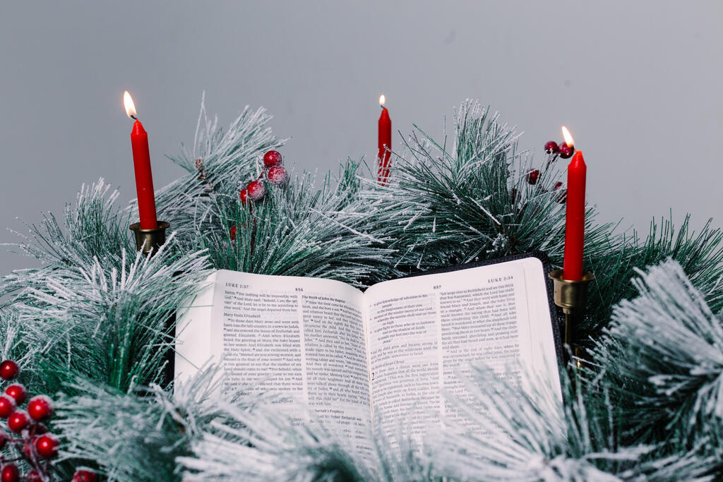 Bible Open to the Christmas Story with Greenery and Candles large preview