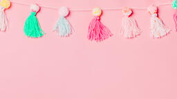 Yarn Tassel Garland on Pink Background  image 1