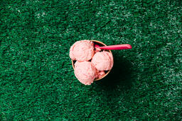 Carton of Strawberry Ice Cream with a Spoon on Grass  image 6