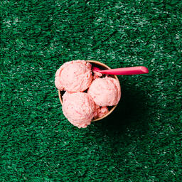 Carton of Strawberry Ice Cream with a Spoon on Grass  image 7