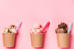 Cartons of Ice Cream with Spoons on Pink Background  image 4