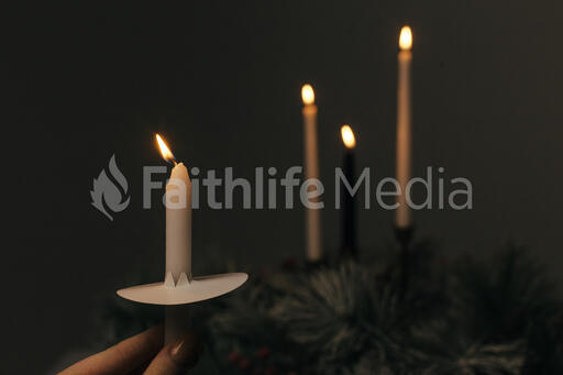 Hand Holding a Candle for a Christmas Candlelight Service